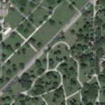 Distinctions can also be seen between the naturalistic Forest Hill layout (southeast of Speedway Road) and the straight, streamlined layout of neighboring Resurrection Cemetery (northwest of road). Source: Google. Forest Hill and Resurrection cemeteries